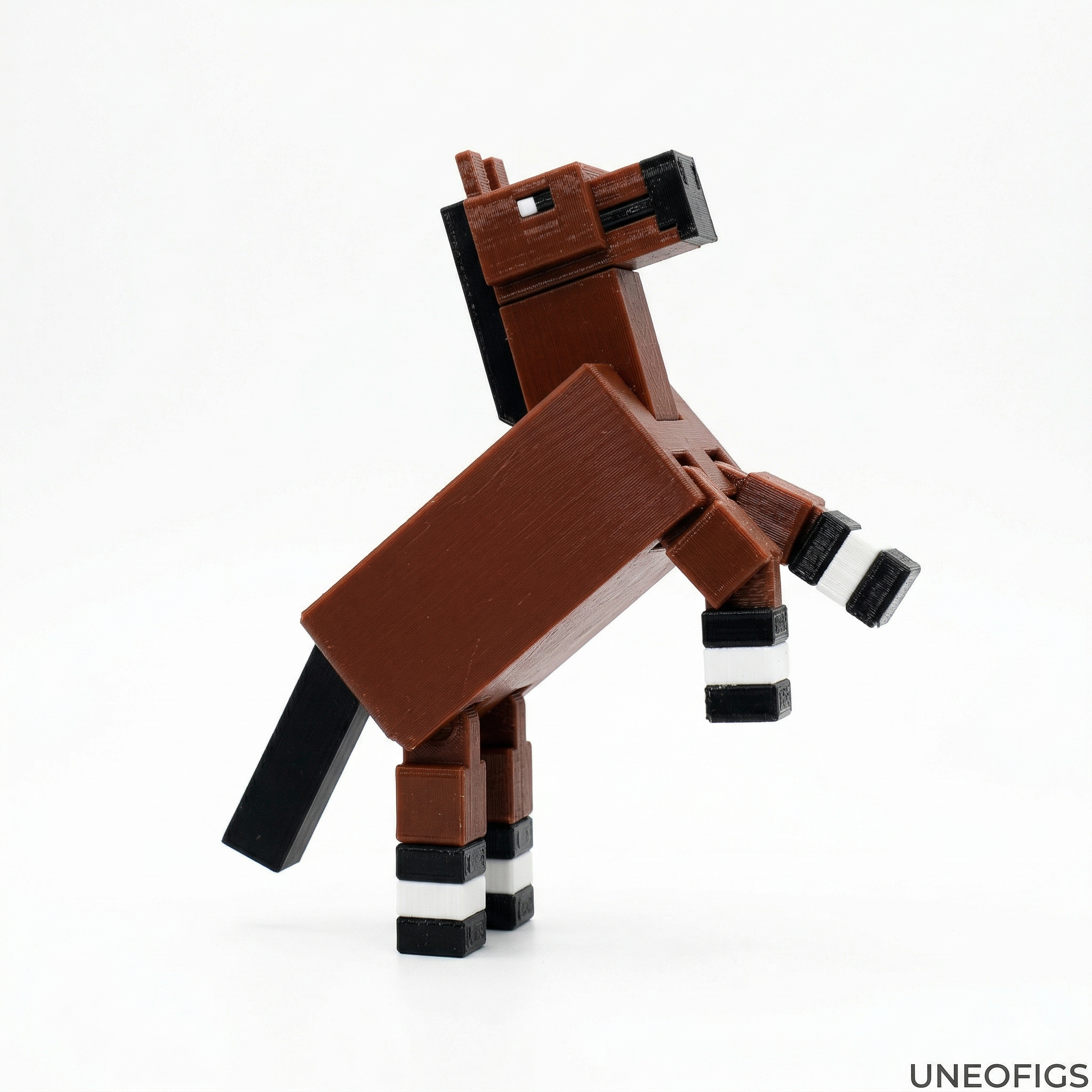 3D printed articulated voxel action figure of Midnight horse-Voxel (Spidey-homage in black and white suit with red accents and glider wings), posed dynamically leaping over a voxel cityscape at sunset. Articulated fidget toy.