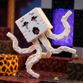 3D printed articulated voxel figure of an orange miner with a glowing pickaxe in a canyon biome.