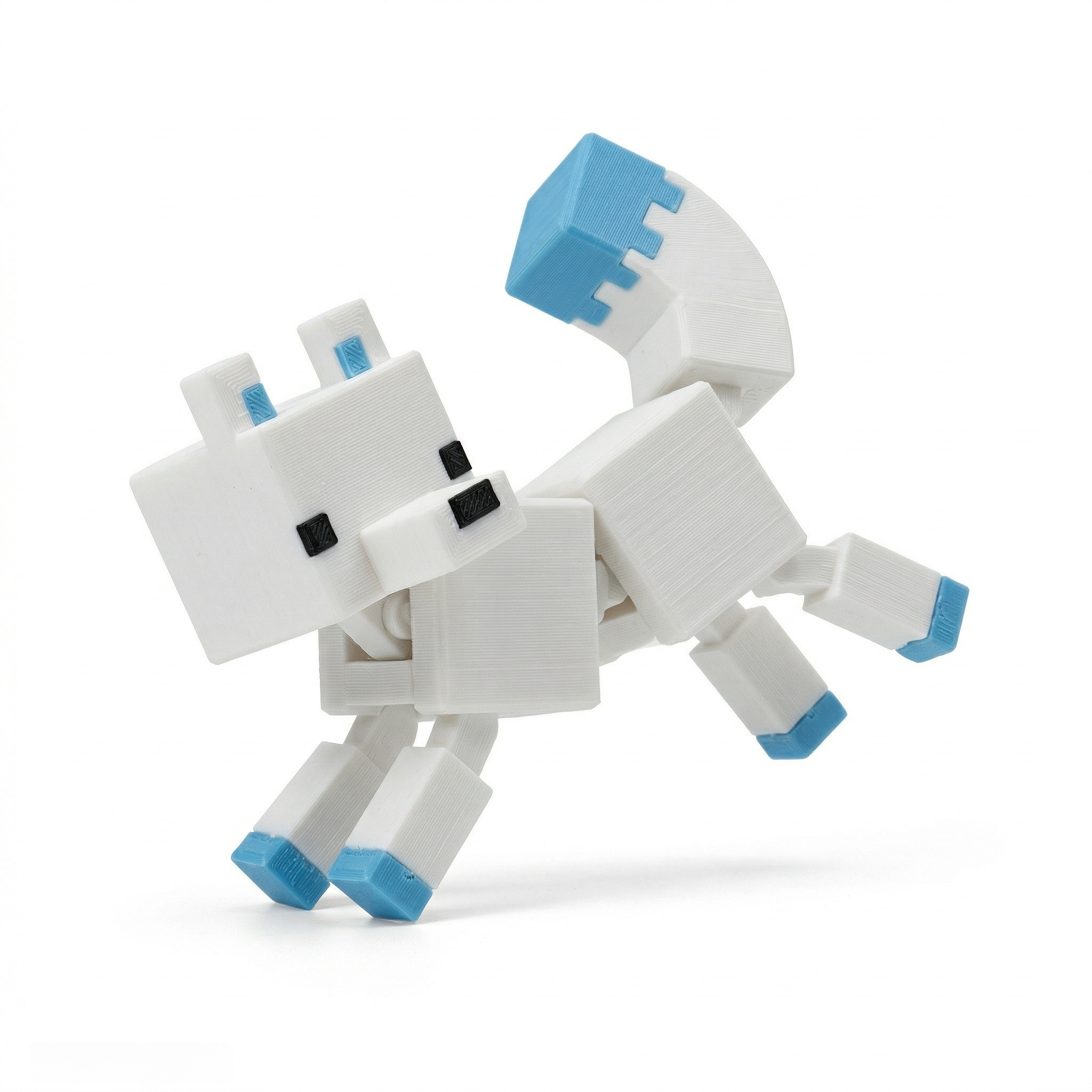 3D printed articulated voxel figure of a white arctic fox with blue accents leaping through a blocky snow biome.
